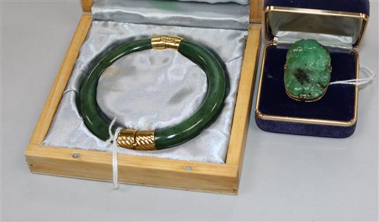 A modern jade and yellow metal-mounted bangle (unmarked) and a similar tablet ring,